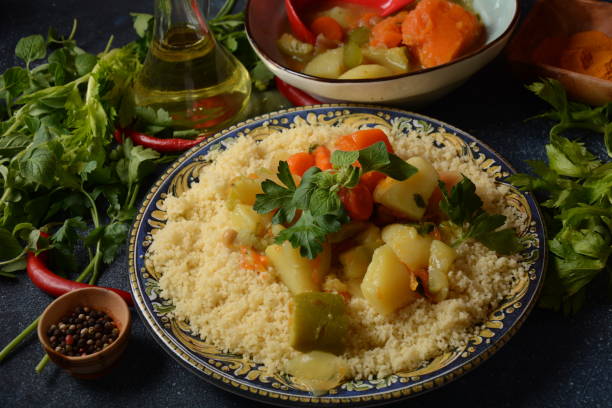 istock Cooked couscous with green parsley in  ceramic plate and vegetable stew. 1291148741