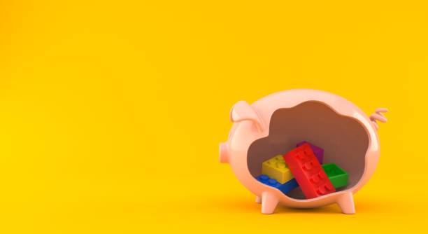 Toy block inside piggy bank isolated on orange background. 3d illustration