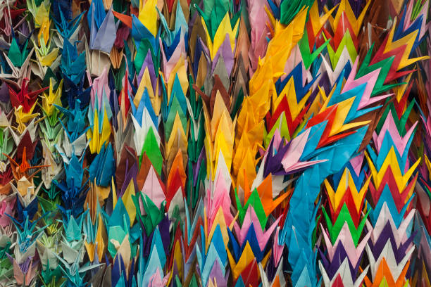 Horizontal close-up view of some colorful paper cranes sent by children from all over the world close to the Children's Peace Monument, Peace Memorial Park, Hiroshima, Japan