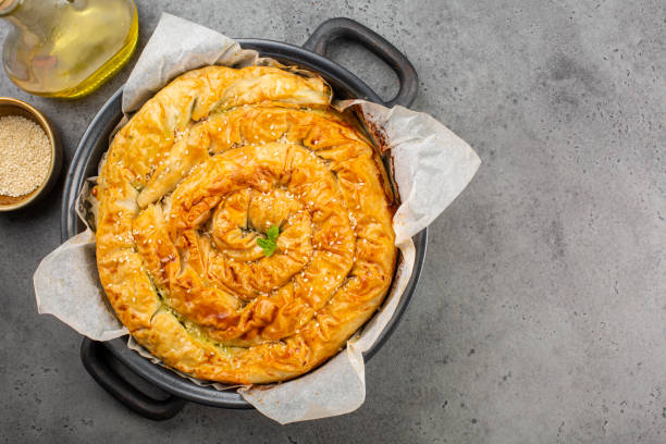 istock Rolled Burek - savoury pie foth feeling, decorated with sesam seedes. Top view. 1291152607