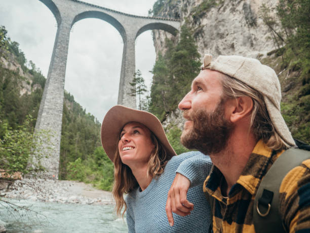 istock Couple contemplate viaduct from the river below, Switzerland 1291153983