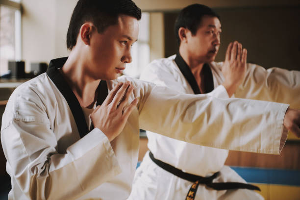 istock Two martial arts students in white keikogi training together. 1291154222