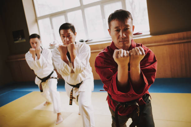 istock Sensei and two martial arts students in white keikogi training together. 1291154225