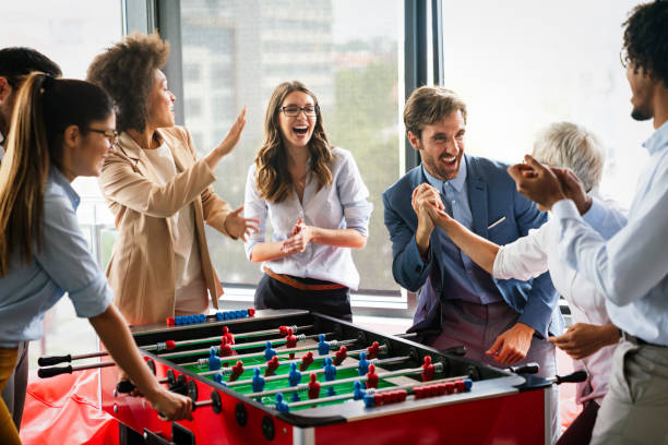 istock Coworkers playing table football on break from work 1291154264