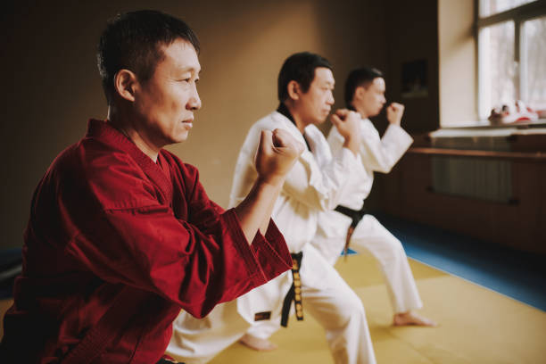 istock Sensei and two martial arts students in white keikogi training together. 1291154268