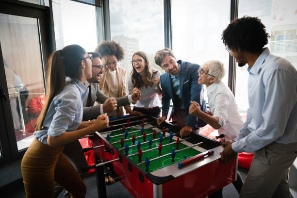 istock Coworkers playing table football on break from work 1291154274