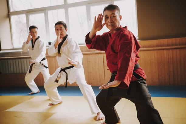 istock Sensei and two martial arts students in white keikogi training together. 1291154313
