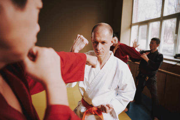 istock Two martial arts fighters in white and red keikogi training together. 1291154521