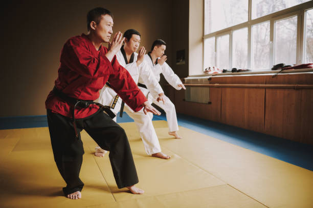 istock Sensei and two martial arts students training together. 1291154571
