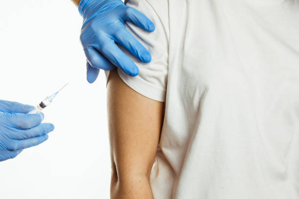 istock making injection of vaccine in shoulder 1291155583