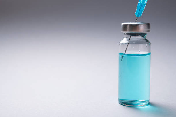 istock Closeup of glass bottle with coronavirus medication 1291155830