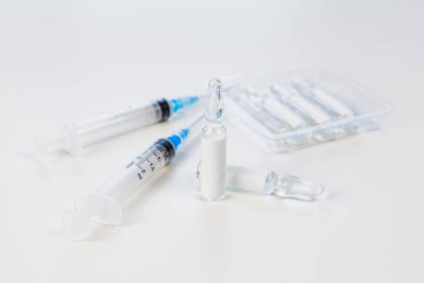 istock view of syringe with vaccine ampoules 1291156273