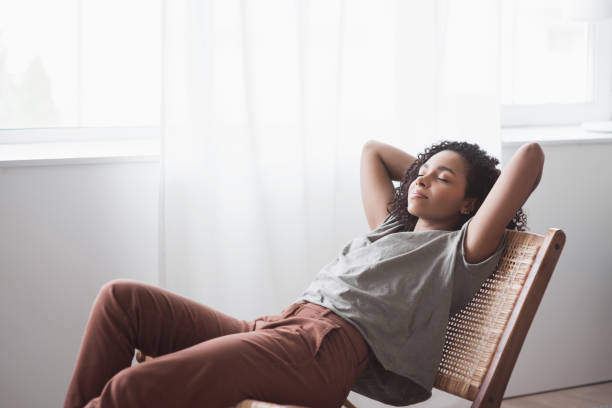 istock Young woman relaxing at home 1291156295