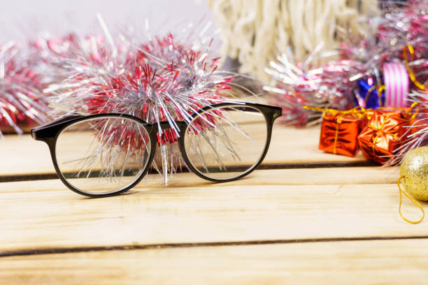 istock Glasses and Christmas decorations on a wooden background. . 1291160022
