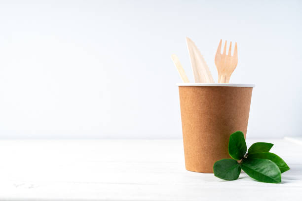 istock Craft paper coffee cup, green leaves sprout, 1291160036