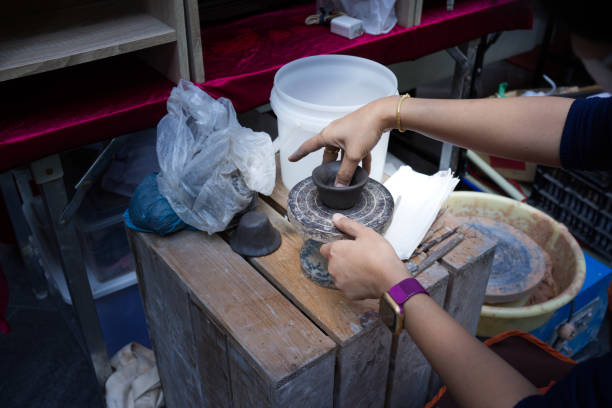 istock Concept Ceramic workshop. Woman leaping clay pots on a  wheel. 1291161432