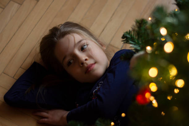 istock girl is lying on the floor under christmas tree 1291161930