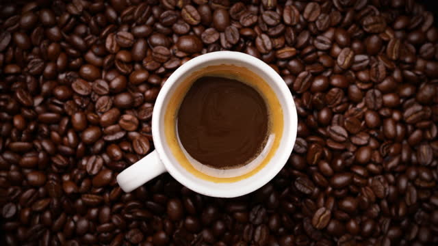 espresso shot with coffee beans background (looping)