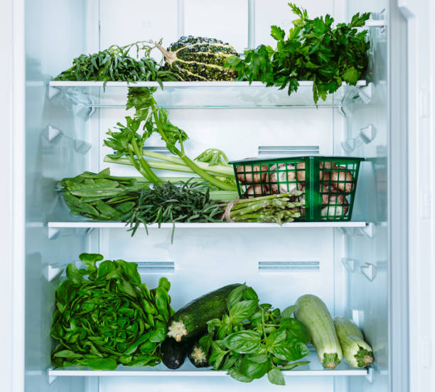 istock Green vegetables and greens in open refrigerator 1291162712