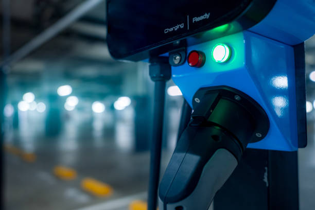 istock Electric car charging station for charge EV battery. Plug for vehicle with electric engine. EV charger. Clean energy. Charging point at car parking lot. Green power. Future transport technology. 1291162955