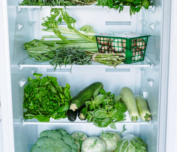 istock Green vegetables and greens in open refrigerator 1291163053