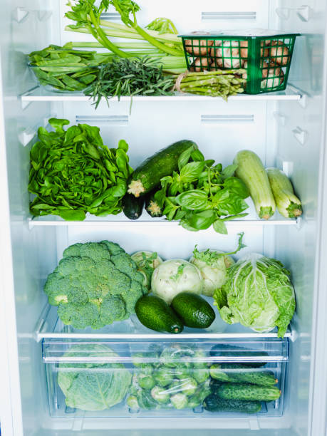 istock Green vegetables and greens in open refrigerator 1291163202