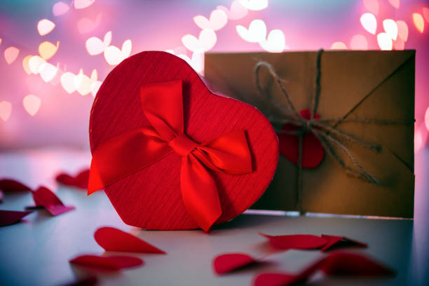 istock Valentines day background with heart shape gift and envelope with red heart 1291164311