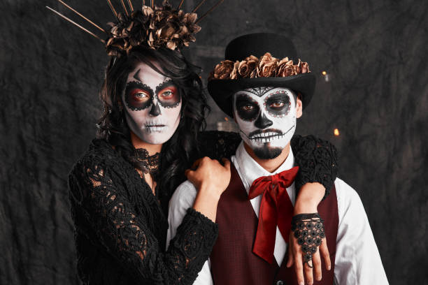 We're hear to celebrate our ancestors Cropped portrait of an affectionate young couple dressed in their Mexican-style halloween costumes face paint halloween adult men stock pictures, royalty-free photos & images
