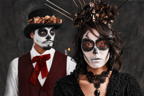 Remembering those we've lost Cropped portrait of an affectionate young couple dressed in their Mexican-style halloween costumes face paint halloween adult men stock pictures, royalty-free photos & images
