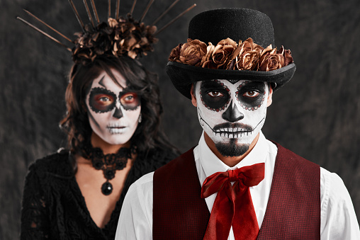 Cropped portrait of an affectionate young couple dressed in their Mexican-style halloween costumes