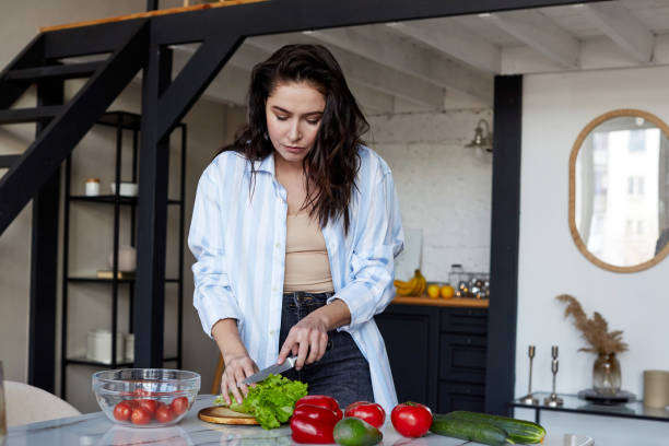 istock Woman cooking at home 1291164771