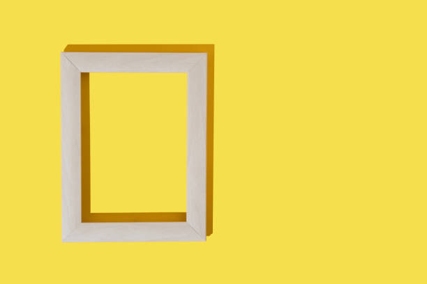 istock Grey frame for photo or painting on bright  yellow background. Mockup. Place to insert text, images. Top view. Flat lay. 1291167007