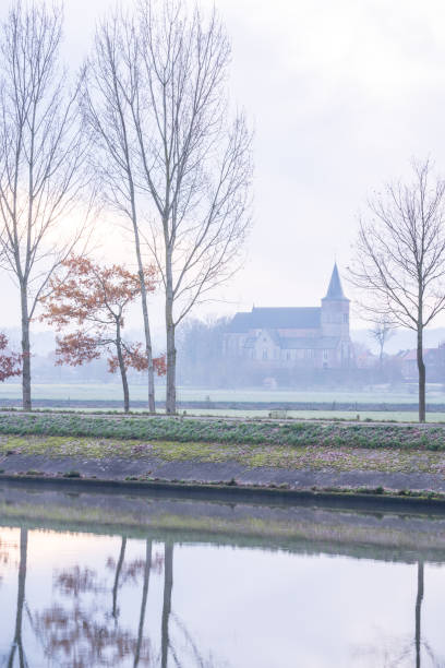 church along the water with fog