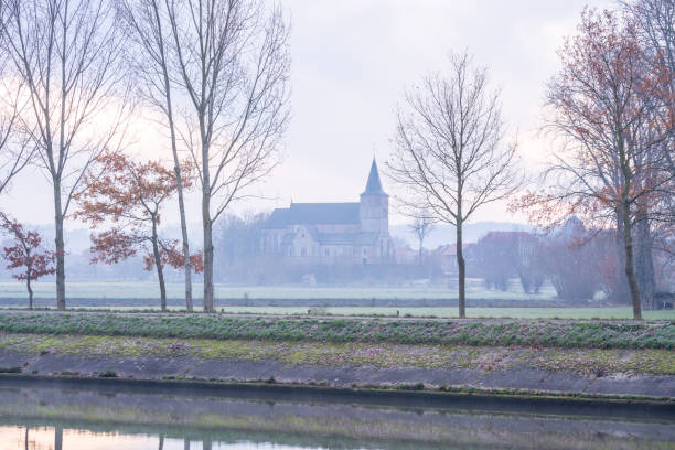 istock church along the water with fog 1291170144
