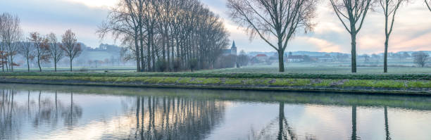 istock church along the water with fog 1291170145