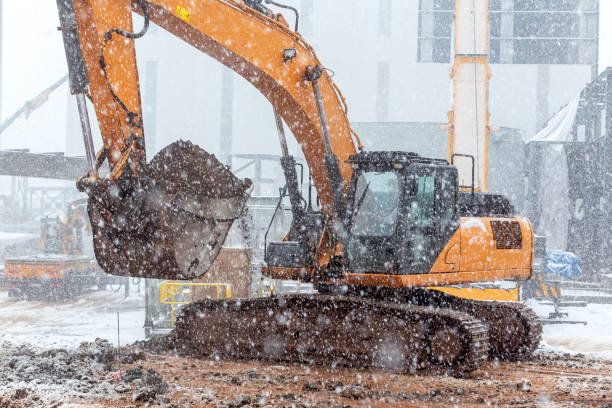 istock The big excavator is digging in snowy weather. 1291171891