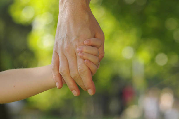 istock child and mother holding hands 1291172121