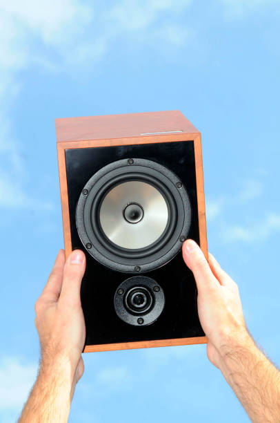 istock holding speakers in blue sky 1291172231