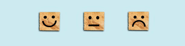 istock Customer service evaluation and satisfaction survey concepts. Face icon on wooden cube 1291173028