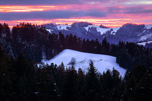 Colorful winter sunset sky in Alps Mountains. Amazing sunset sky landscape.