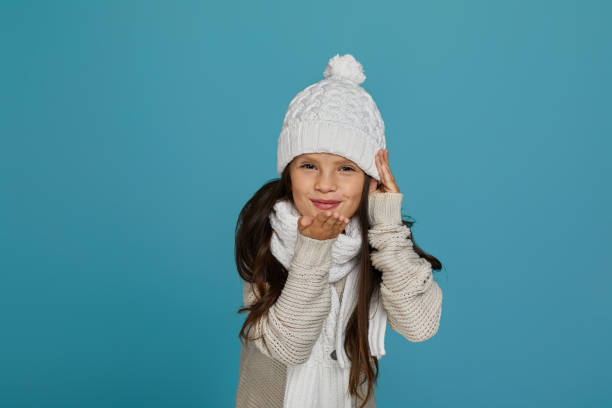 Little girl in winter clothes outdoors.