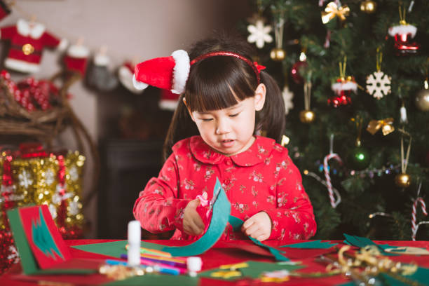 istock young girl making Christmas craft at home 1291174549