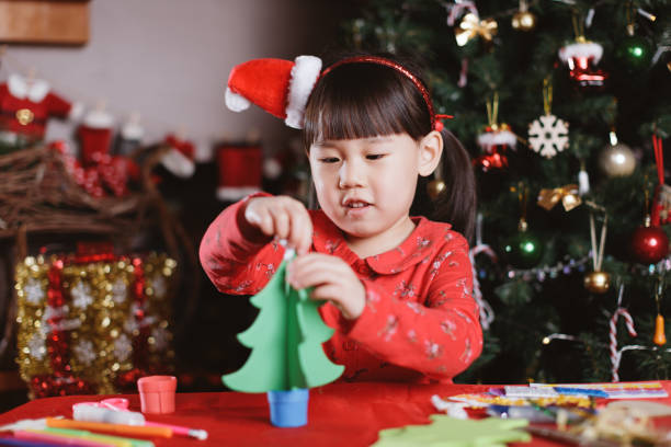 istock young girl making Christmas craft at home 1291174681