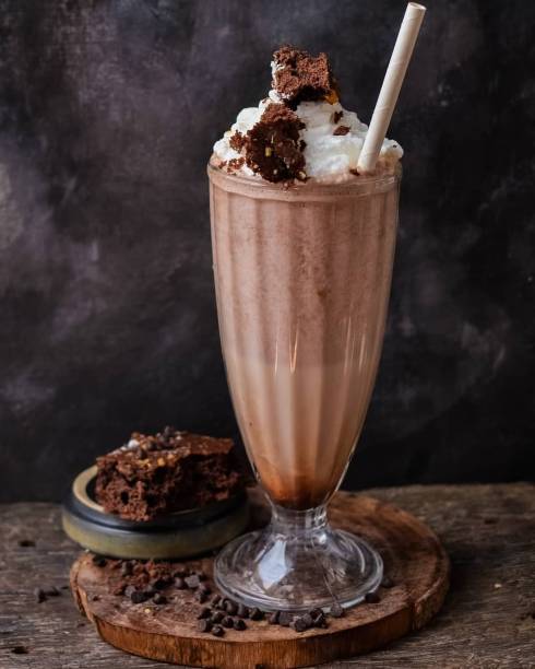 Chocolate milkshake Hot chocolate with whipped cream , chocolate shake with choco chips spread and black background chocolate shake stock pictures, royalty-free photos & images