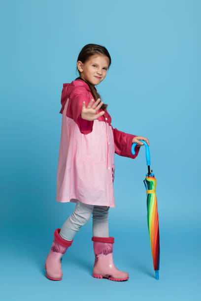 istock cute child girl with multicolored umbrella 1291175550