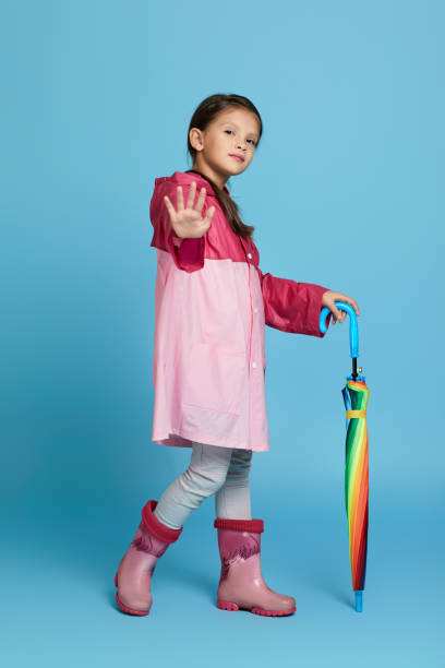 istock cute child girl with multicolored umbrella 1291175681