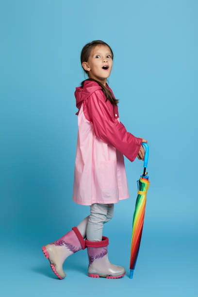 istock cute child girl with multicolored umbrella 1291176298
