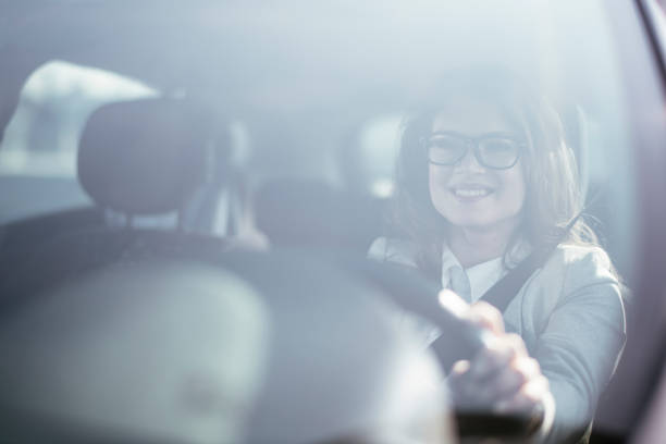 istock Businesswoman driving car. 1291176318
