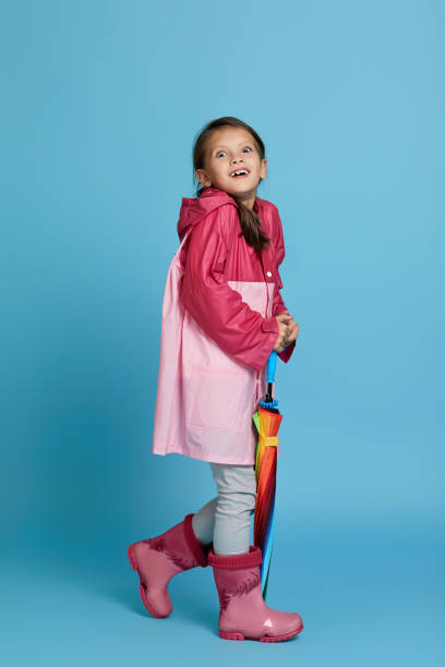 istock cute child girl with multicolored umbrella 1291176402