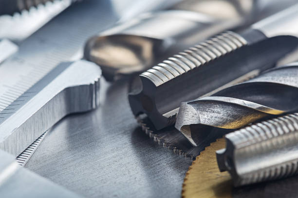 istock set of different drill bits,thread tap and mill cutters with vernier caliper on steel plate background. Locksmithing deal. 1291177057